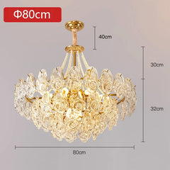 Gold chandelier with crystal details and dimensions on a gray background