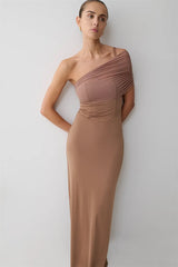 Woman wearing a one-shoulder brown dress against a white background