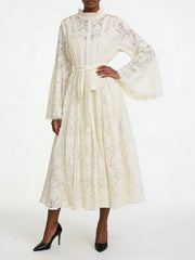 White lace bell sleeve midi dress with hand on hip