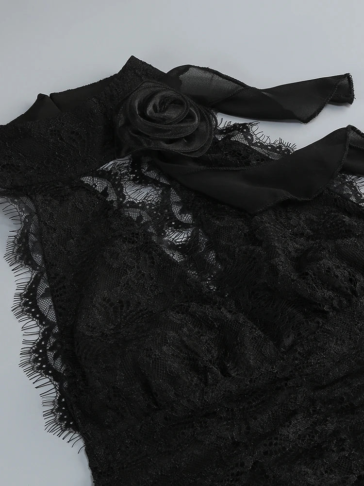 Black lace garment with a rose detail on a white background