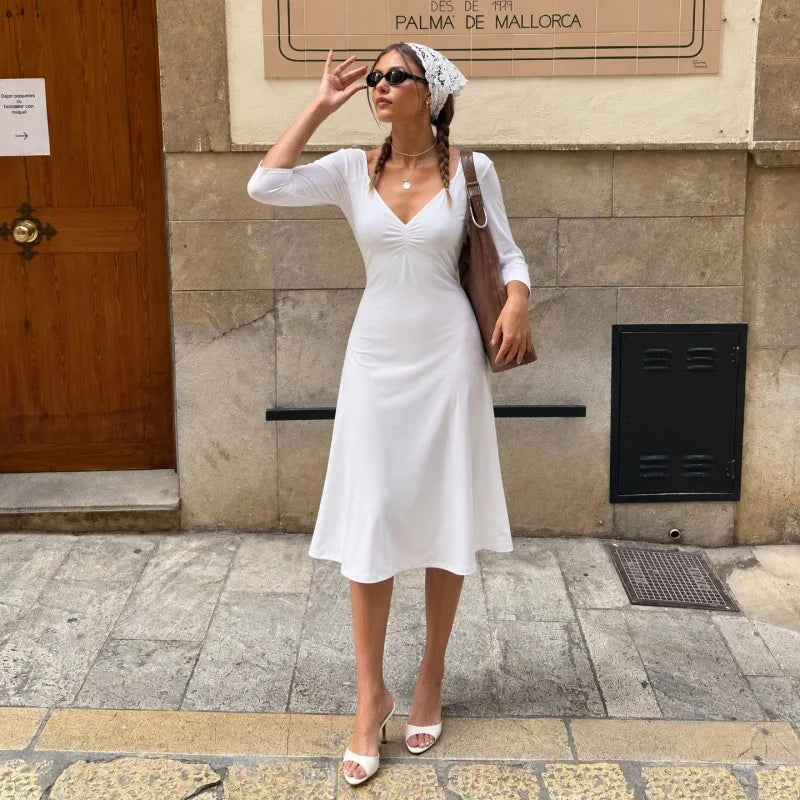 White midi dress with a v-neck and three-quarter sleeves