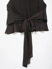 Black strapless top with ruffled details on a white background