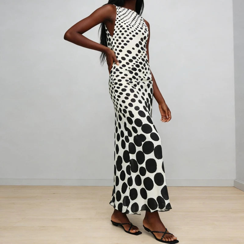 Side profile of a dot print sleeveless maxi dress with floor-length skirt