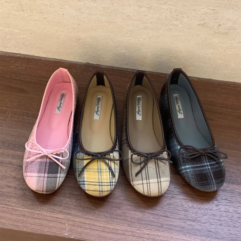 Four pairs of checked ballet flats lined up