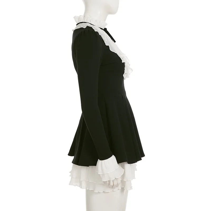 Black dress with white ruffled details on a mannequin against a white background