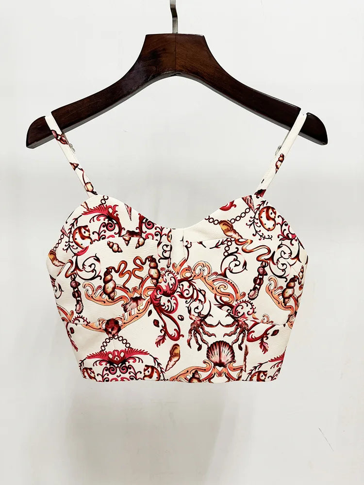 Close-up of a white camisole top with a sea world print, hung on a hanger.