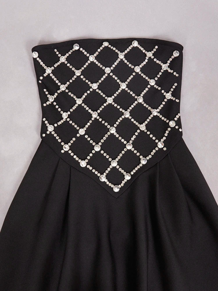 Black strapless dress with a grid pattern of pearls on a gray background