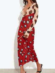 Side view of a tie neck maxi dress with sheer flare sleeves.