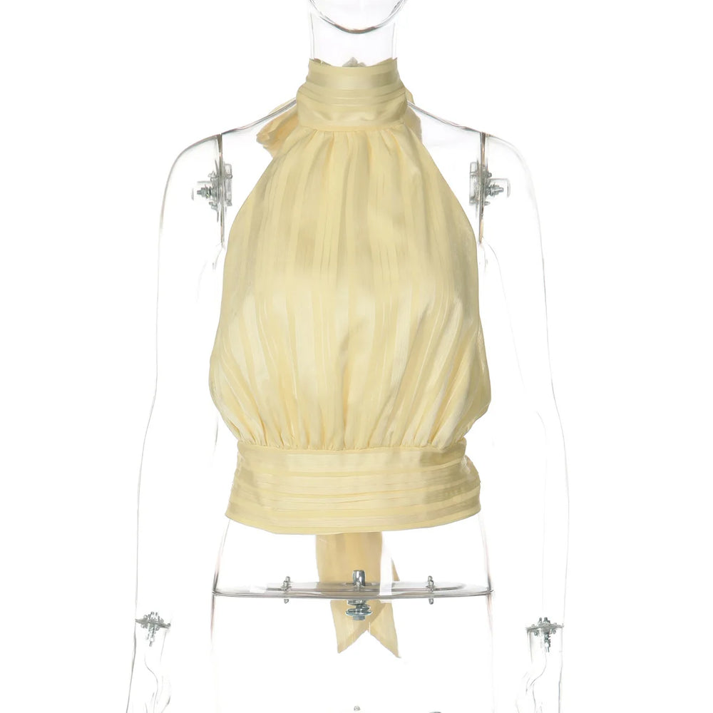 Yellow halter top on a mannequin against a white background