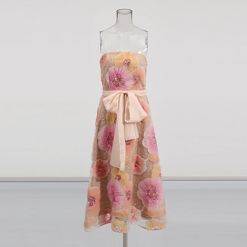 Floral dress with a bow on a mannequin against a white background