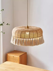 A Japanese Wabi-Sabi hemp rope pendant light with a woven design, casting a warm glow in a minimalist living room. B