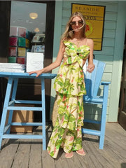 A woman wearing a colorful 3D floral ruffle maxi dress with a tiered skirt, ideal for summer events. 2