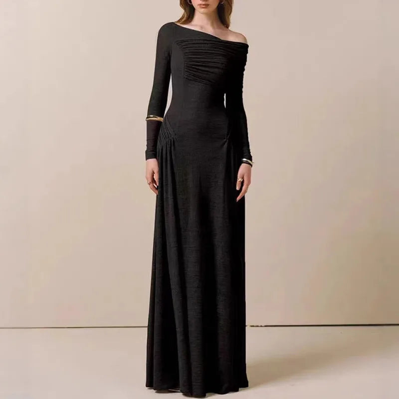 Black one-shoulder evening gown on a neutral background