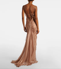 Back view of a floor-length ruched spaghetti strap evening gown with lace-up detail.