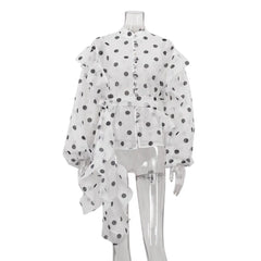 White sheer blouse with black polka dots on a mannequin against a white background