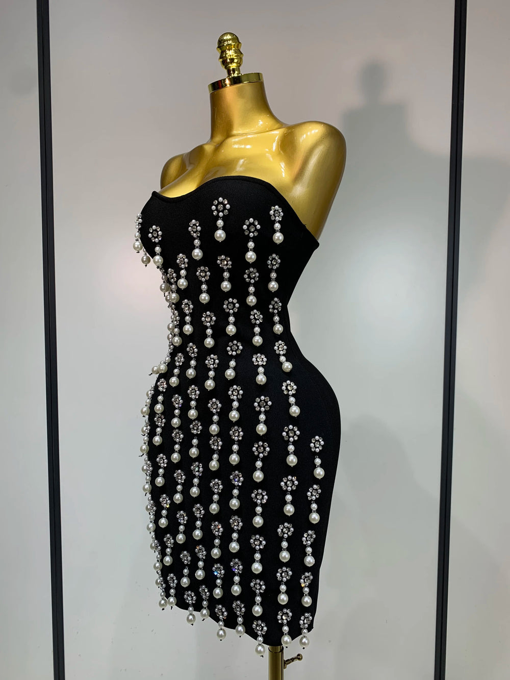 Side view of strapless pearl and rhinestone bodycon mini dress