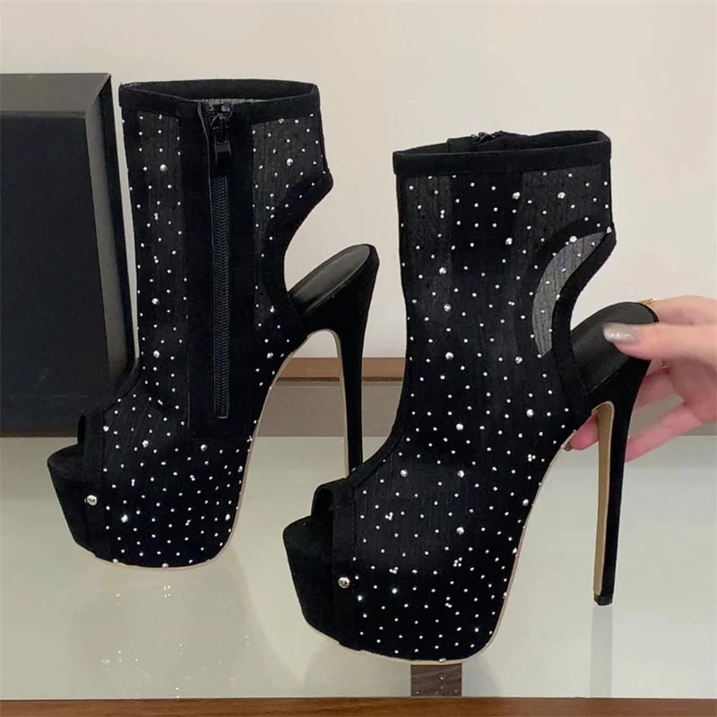 Close-up of black rhinestone mesh peep toe stiletto ankle boots