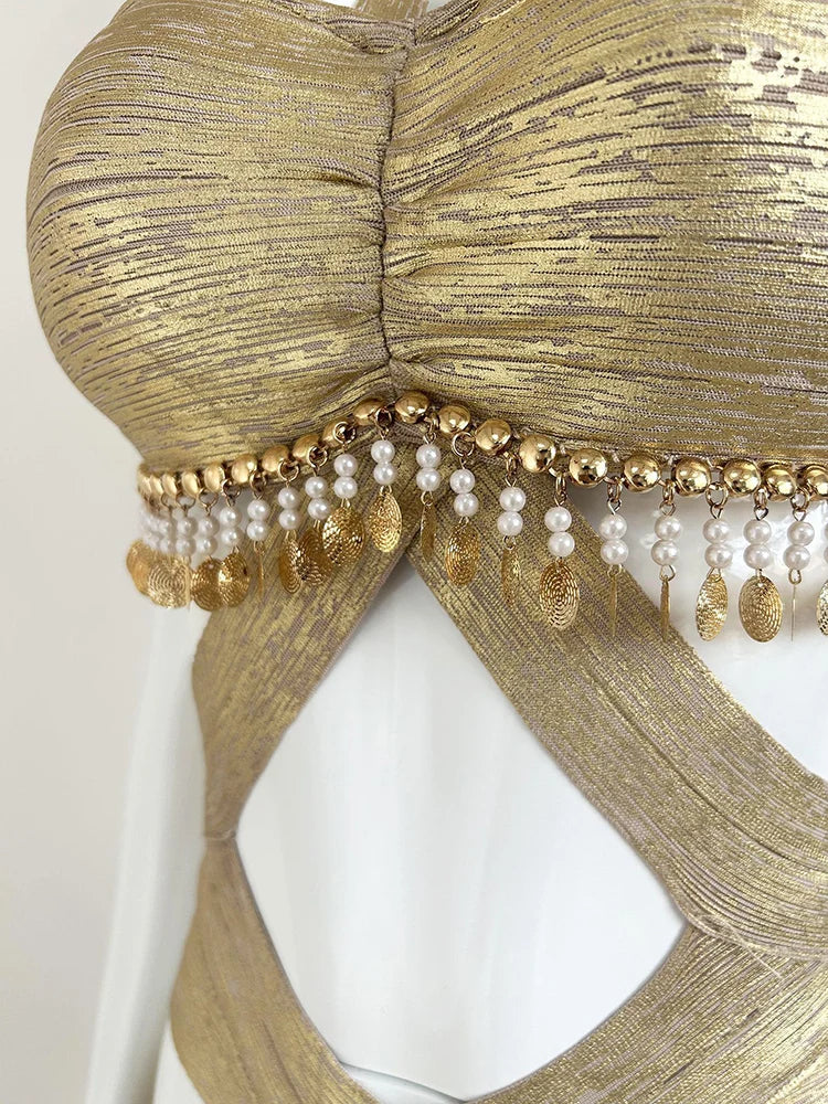 Detail of beading and sequins on gold halter dress