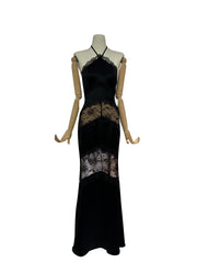 Black evening gown with lace details on a mannequin against a white background