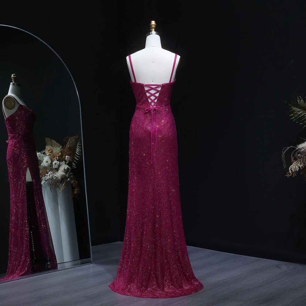 Pink evening gown on a mannequin against a dark background