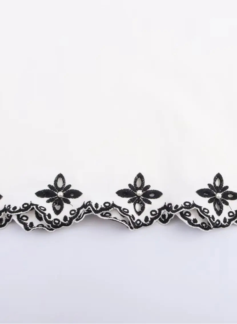 Black floral lace trim on a white background