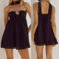 Black dress with a brooch detail shown from front and back on a plain background