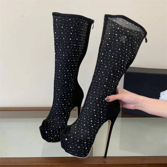 Black mesh peep toe knee-high platform boots with crystal embellishments shown with hand