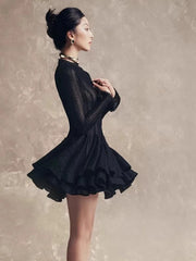 Woman wearing a black dress against a neutral background