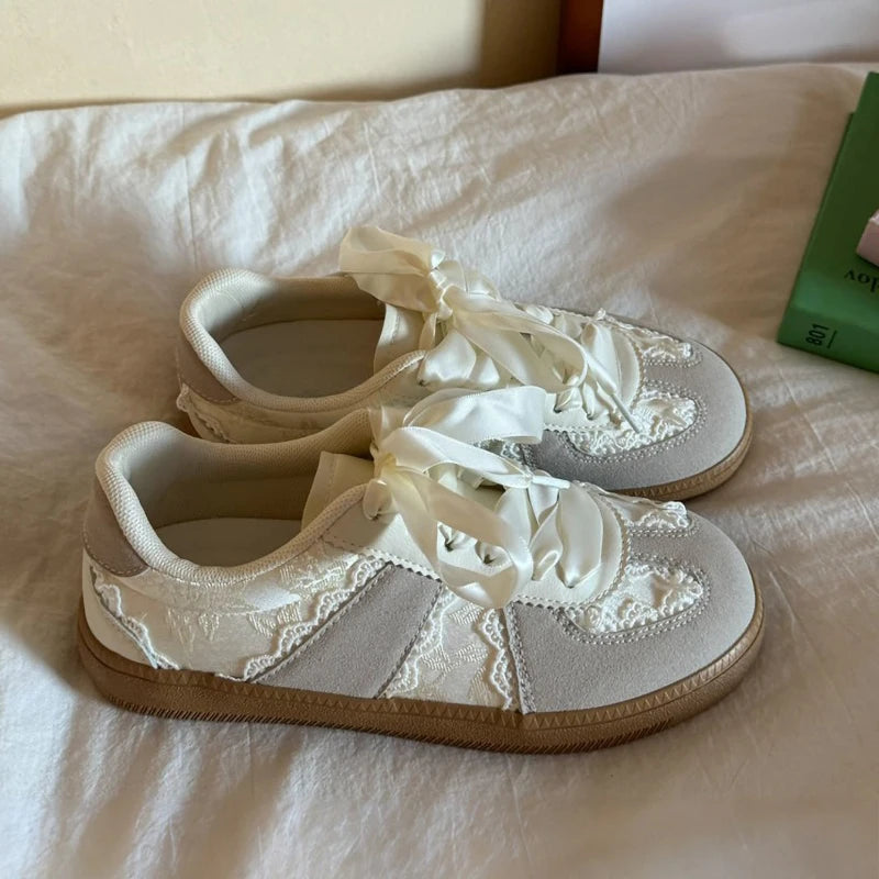 Beige lace-up ballet flats with ribbon ties