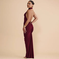 Woman wearing a burgundy evening gown with a beige background