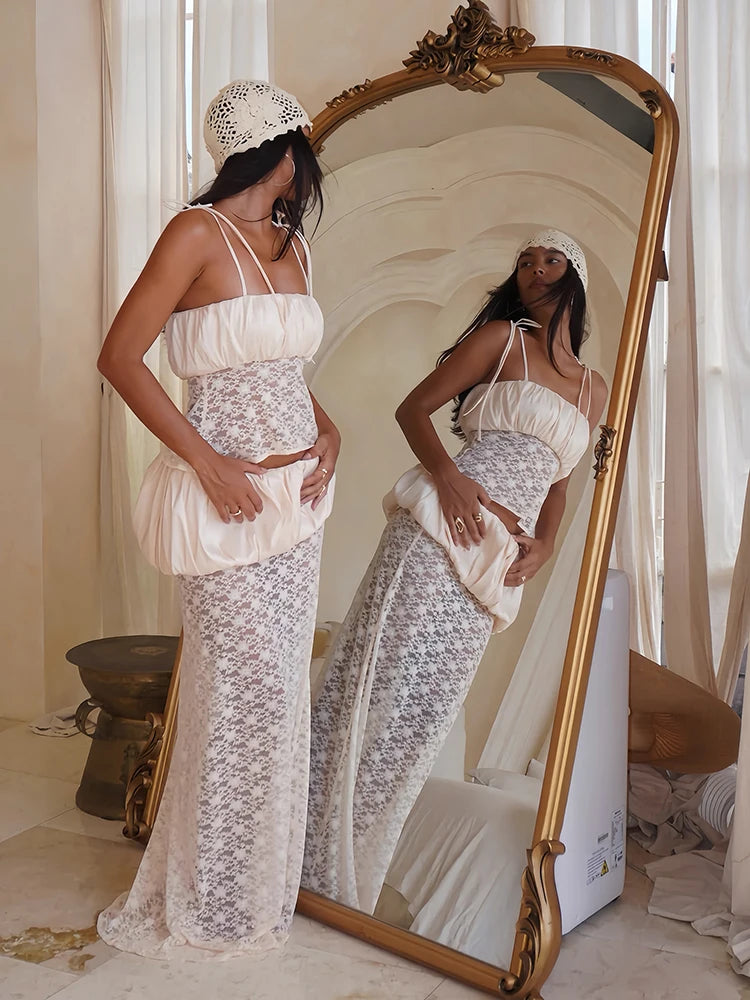 Reflection of a ruched satin camisole and lace maxi skirt set in a mirror.