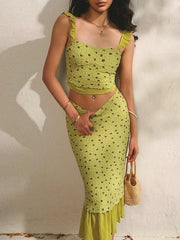 Woman wearing a green lace outfit against a light background