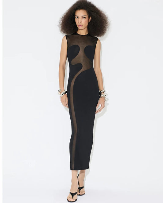 Woman wearing black mesh panel dress against a white background