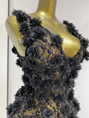 Close-up of black floral appliqué V-neck mini dress details