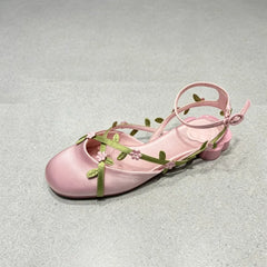 Close-up of pink silk floral kitten heel sandal detail