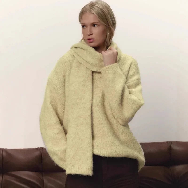 Woman wearing a light green sweater with a plain background