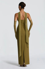 Woman wearing a long green dress with gloves on a white background