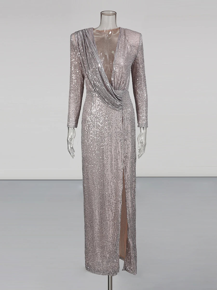 Silver sequin evening gown on a mannequin against a plain background
