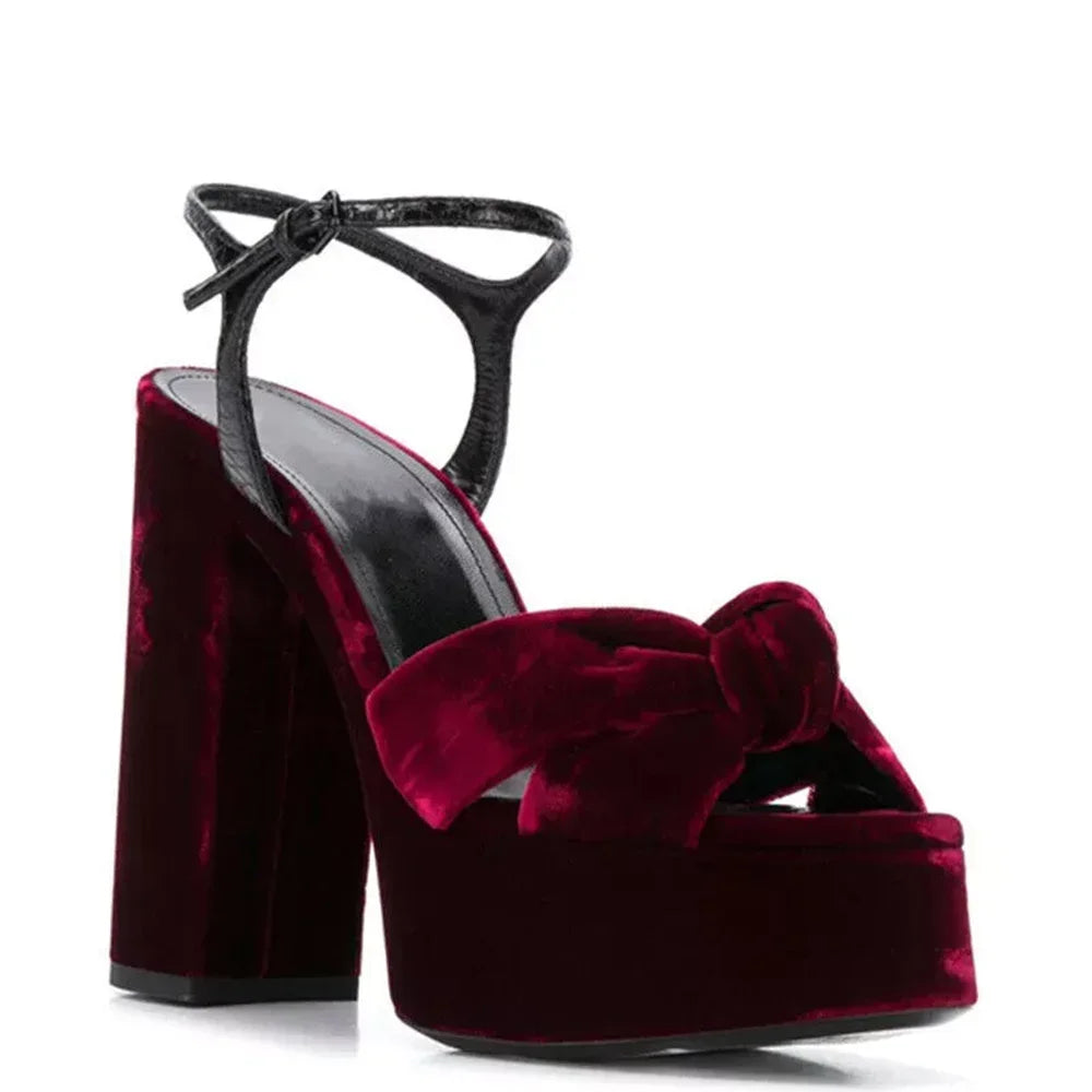 Burgundy velvet platform slingback heel with knot detail and black ankle strap.