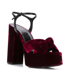 Burgundy velvet platform slingback heel with knot detail and black ankle strap.