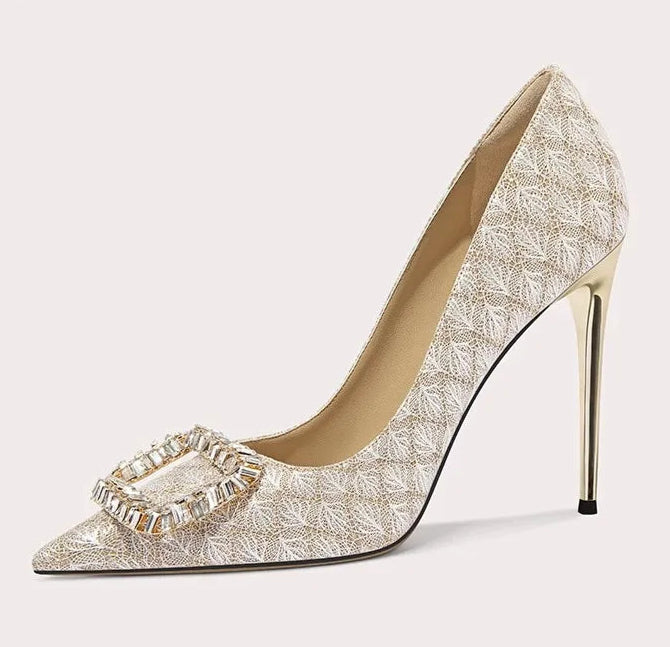 High-heeled shoe with decorative strap on a light gray background