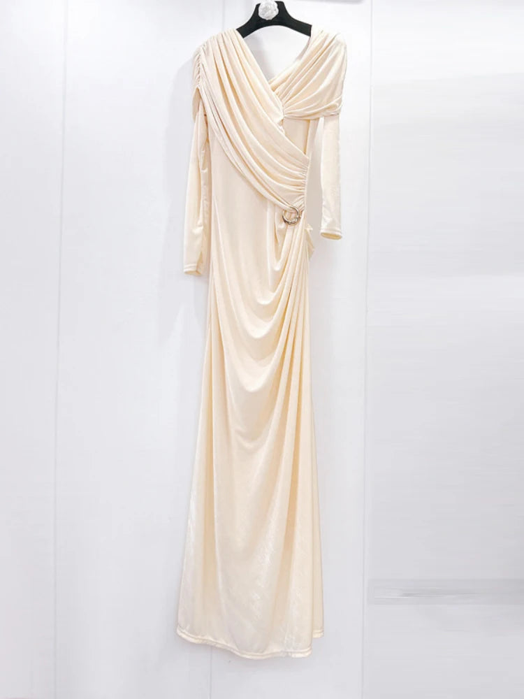 Beige evening gown on a hanger against a white background