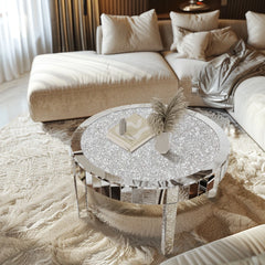 Round crystal coffee table in a living room setting with a beige sofa and decorative pillows.
