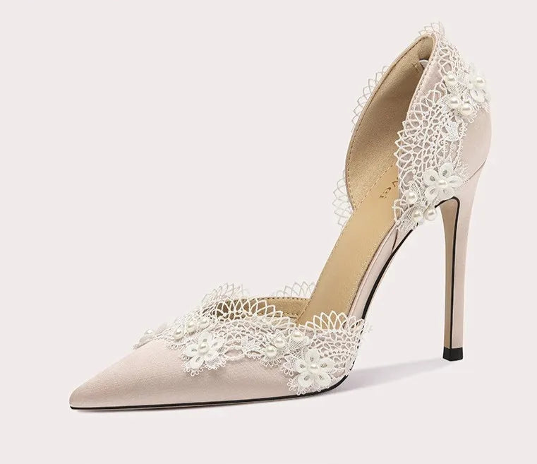 High-heeled shoe with lace detailing on a white background