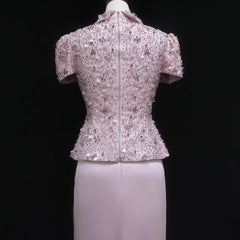 Short-sleeve sequined top on a mannequin against a black background