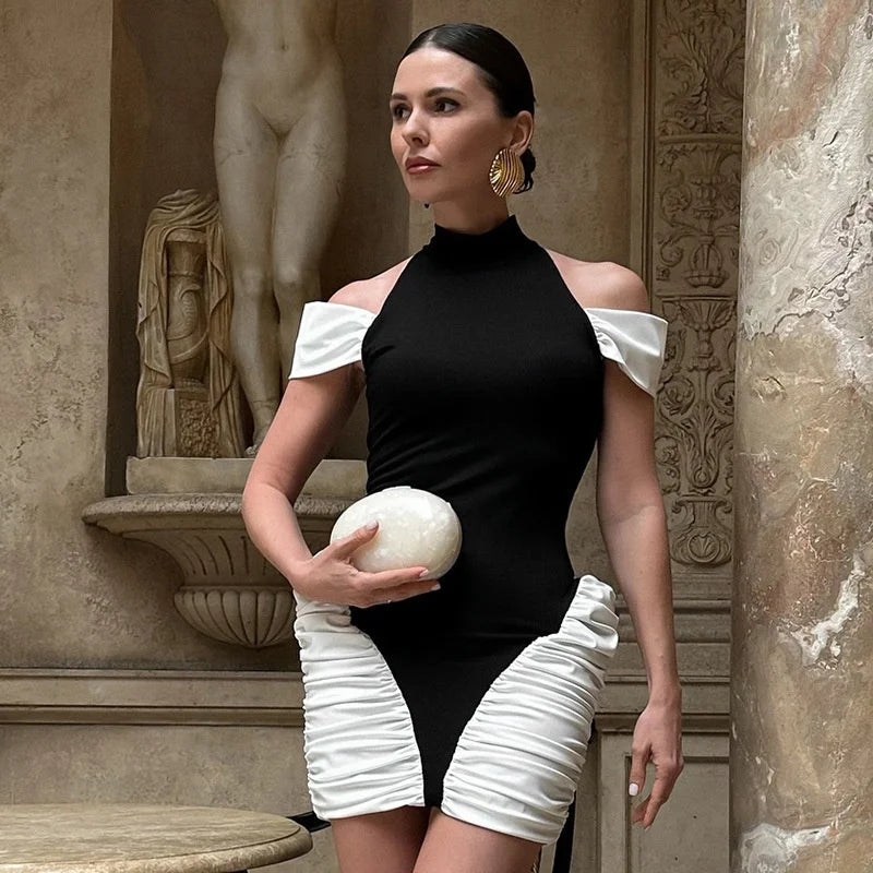 Woman in a black and white outfit holding a sphere in an ornate setting