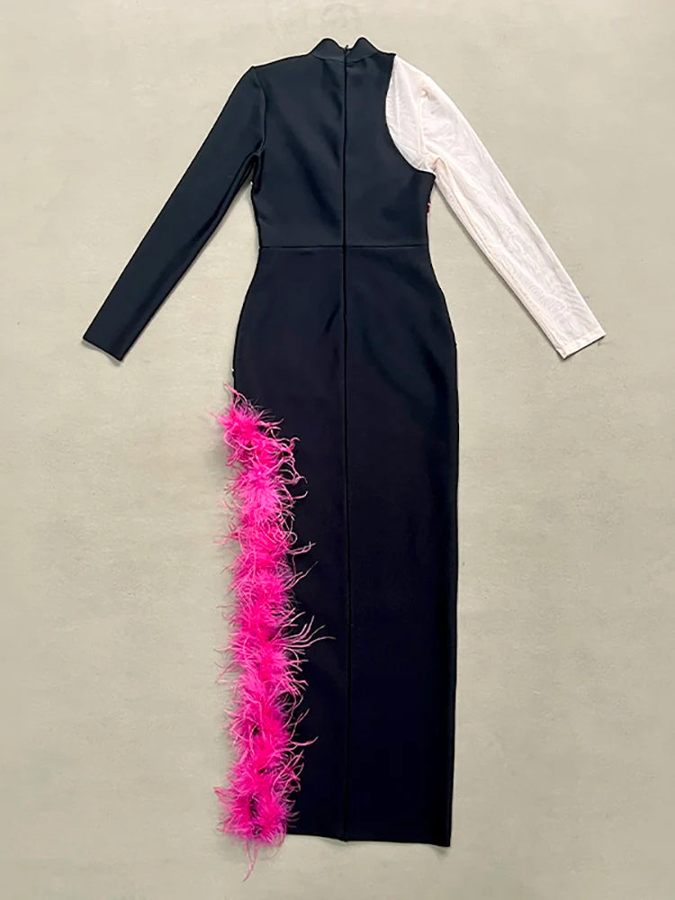 Black dress with pink feather details on a beige background