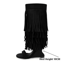 Heel height detail on black fringe wedge heel boots