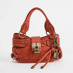 orange PU mini handbag with rivet hardware,
