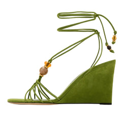 Side view of green suede strappy wedge sandals with natural stone beads